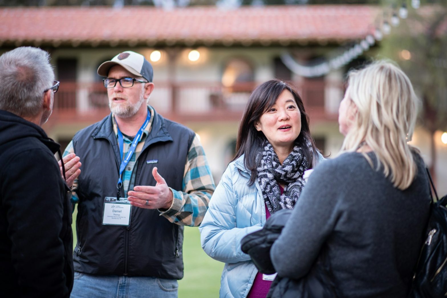 A small group of people talking outdoors