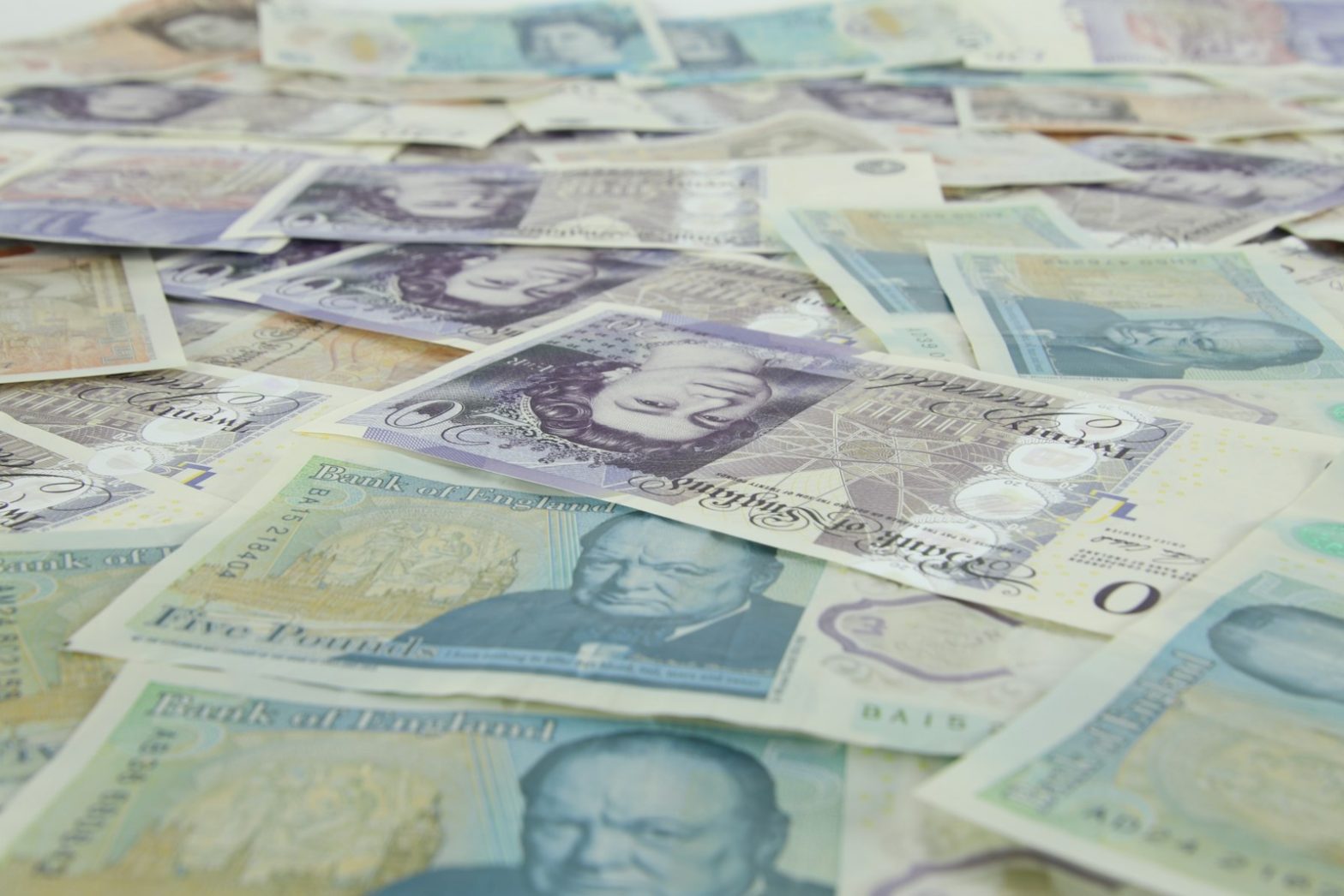 British banknotes scattered across a table