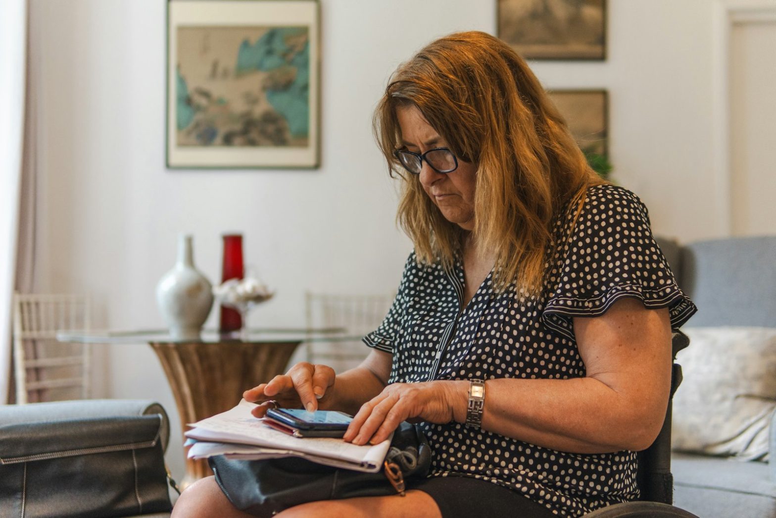 A woman going through paperwork at home