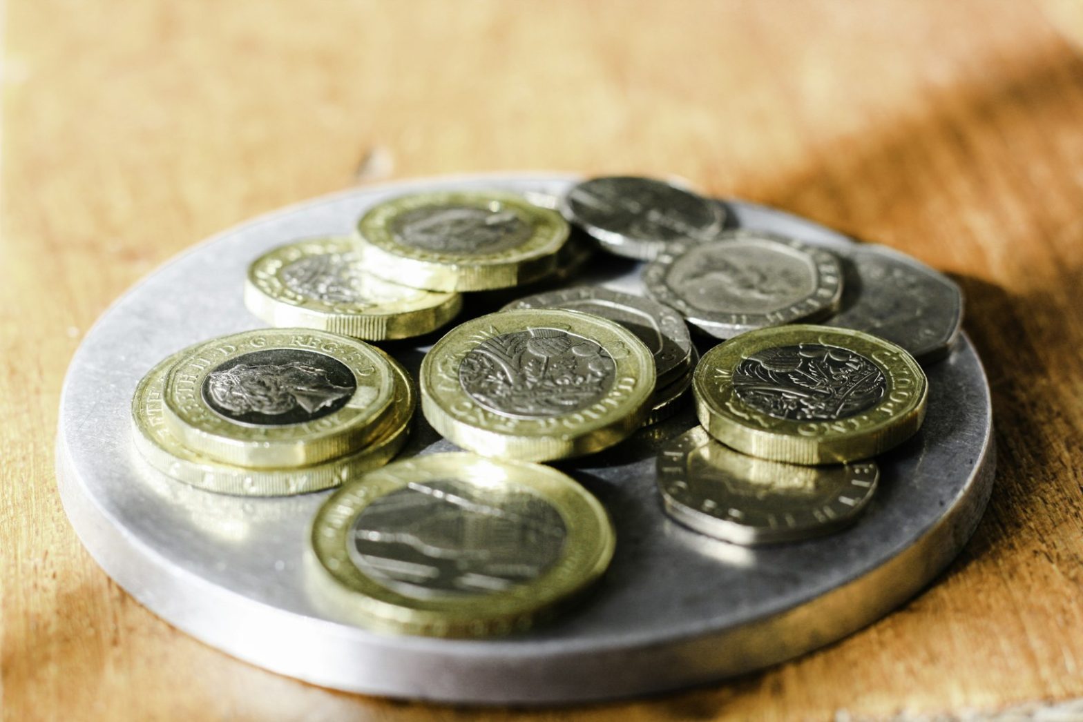 A small dish of British pound coins