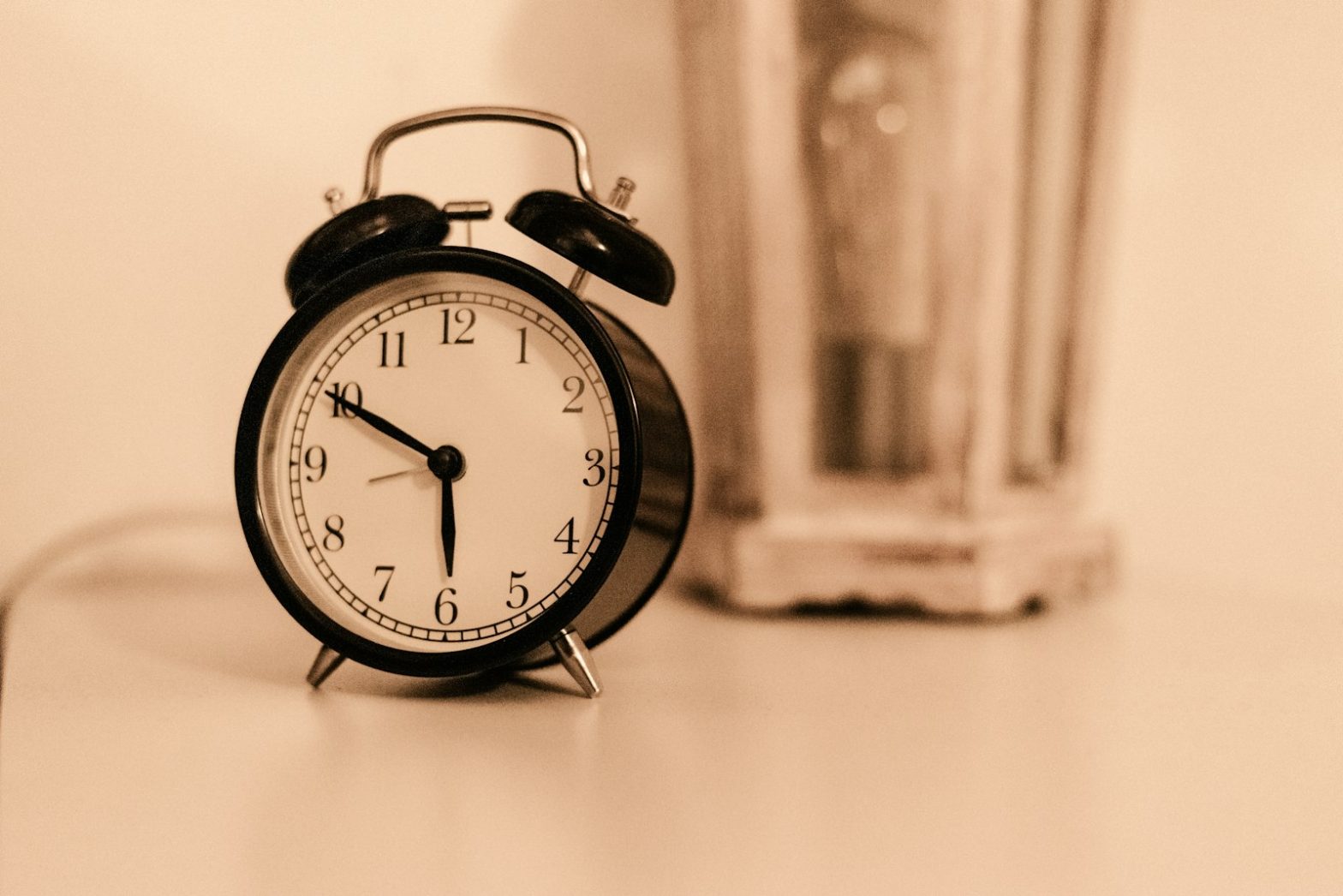 A black alarm clock on a table